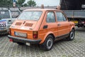 Old Polish private small simple cheap car orange Polski Fiat 126p parked Royalty Free Stock Photo