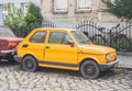 Classic Polish small car Polski Fiat 126p yellow compact parked Royalty Free Stock Photo