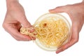 Old poor man eat with hands  long boiled spaghetti pasta from plastic bowl isolated Royalty Free Stock Photo