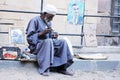 Old poor man selling fruits