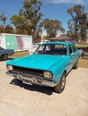 Old popular blue 1970s Dodge 1500 four-door sedan car by Chrysler Argentina in a park.