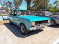 Old popular blue 1970s Dodge 1500 four-door sedan car by Chrysler Argentina in a park.