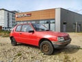 Old classic rusty small compact car Peugeot 205 from eighties parked