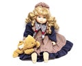 Old porcelain doll on White Background, ceramic dolls and a teddy bear. Royalty Free Stock Photo