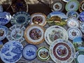 Porcelain plates with beautiful pictures at the flea market Royalty Free Stock Photo