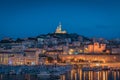 The Old Port and Basilica of Notre Dame de la Garde at dusk in Marseille, France Royalty Free Stock Photo