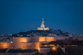 The Old Port and Basilica of Notre Dame de la Garde at dusk in Marseille, France Royalty Free Stock Photo