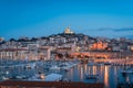 The Old Port and Basilica of Notre Dame de la Garde at dusk in Marseille, France Royalty Free Stock Photo