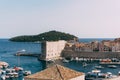 The old port harbor is porporela, near the walls of the old town of Dubrovnik, Croatia. View of the fort on the wall Royalty Free Stock Photo