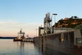 Old port installations, boat anchored in the St. Lawrence River and ferry terminal seen at sunrise