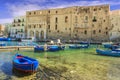 Old port of Monopoli province of Bari, region of Apulia, southern Italy: view of the old town with fishing and rowing boats, Italy