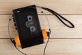 Old portable cassette player on a wooden background