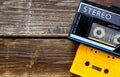 Old portable cassette player on a wooden background. image is instagram style filtered.