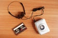 Old portable cassette tape player and headphones on wooden Royalty Free Stock Photo