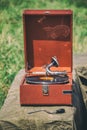 An old portable gramophone plays vinyl record Royalty Free Stock Photo