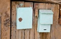 Old post boxes on the wooden wall of slum house in Royalty Free Stock Photo