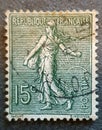 Old postage stamp from France circa 1920 shows agriculture - a woman resembling grain