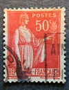 Old postage stamp from France circa 1932 shows peace - a woman with an olive branch