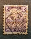 an old postage stamp from Hungary 1917 with the image of some peasants in the field Royalty Free Stock Photo