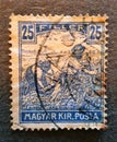 an old postage stamp from Hungary 1917 with the image of some peasants in the field Royalty Free Stock Photo