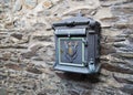 Old postbox on stone wall. Royalty Free Stock Photo