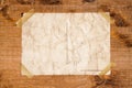 Old postcard stopped with adhesive tape on a grunge wood texture Royalty Free Stock Photo
