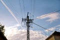 Old Power line electrical wire pillar with street feline lights against the blue sky / Wooden pole of power lines. Royalty Free Stock Photo