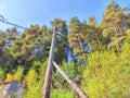 Old power line pole against blue sky in sunny day Royalty Free Stock Photo