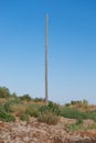 Old power pillar on a summer day. Power line post with electricity cables against a clear blue sky Royalty Free Stock Photo