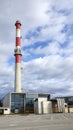 Power plant building with high industrial chimney
