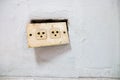 Old power socket on white wall Royalty Free Stock Photo