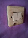 old power switch for lamp mounted on the purple wall Royalty Free Stock Photo