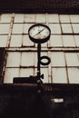 Old pressure gauge with loop and dirty factory window Royalty Free Stock Photo