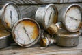 Old pressure gauge on wooden background and empty area for text, damage gauge from operation oil and gas production process Royalty Free Stock Photo