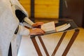 Old priest hands on the bible in the church at the altar. Royalty Free Stock Photo