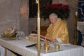 An old priest wearing in a festive golden stole is reading the Bible Royalty Free Stock Photo