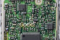 Old printed circuit board with radio components on background. Vintage circuit board with soldering trace, parts and microcircuits Royalty Free Stock Photo