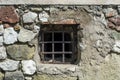 Behind Bars: Vintage Prison Cell with Metal Bars and Rock Brick Wall Royalty Free Stock Photo