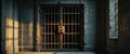 Old prison door with metal bars and dimly lit corridor. Royalty Free Stock Photo