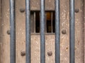 Old prison door with metal bars and window Royalty Free Stock Photo