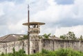 Old prison guard tower or watchtower with security systems barbed wire fence