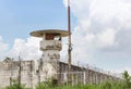 Old prison guard tower or watchtower with security systems barbed wire fence Royalty Free Stock Photo