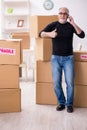 Old male professional mover doing home relocation Royalty Free Stock Photo