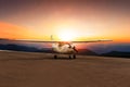 Old propeller plane taxi on airport runway against beautiful sun Royalty Free Stock Photo