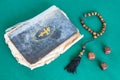 Old psalm book, worry beads and three wooden dices Royalty Free Stock Photo