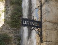 An old public bathroom in Lisbon, Portugal near Castelo, Alfama. Urinol sign with peeing boy