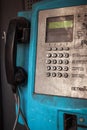 Old public blue payphone closeup, urban mood, dirty rusty buttons Royalty Free Stock Photo