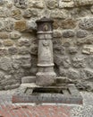 Old public fountain in use in San Gimignano in the provice of Siena, region of Tuscany, Italy. Royalty Free Stock Photo