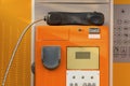Old public phone booth orange color for coins Royalty Free Stock Photo