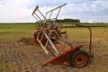 Old grain swather parked in a field